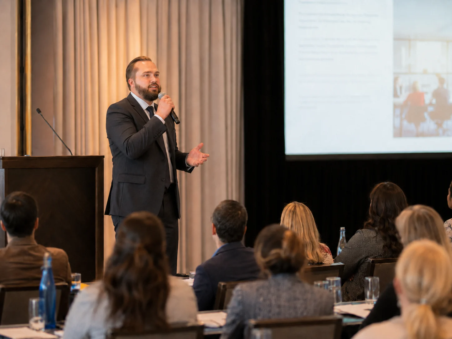 Ben Langner speaking to a room from the front of a conference session